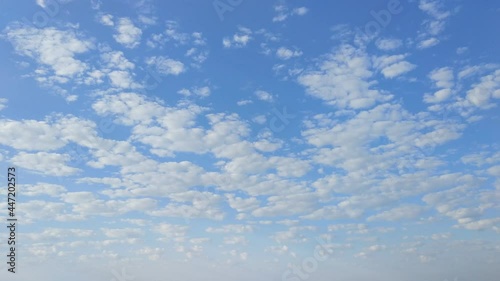 incomparable white clouds in the pale blue sky, like little lambs, float towards, constantly changing shape
