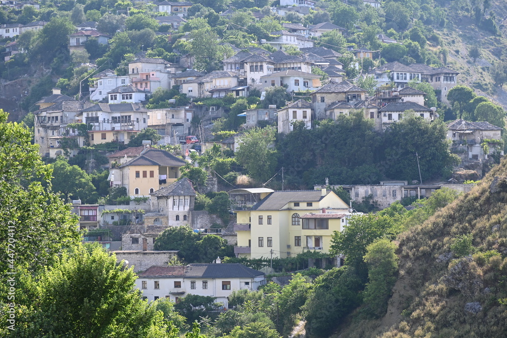 View of the old town of Gjirokastra in Albania with the traditional stone roofs, stone house roof	