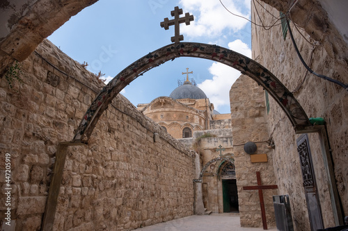 Station 9 on Via Dolorosa, Jerusalem Old City. Cross of Jesus Christ. St. Helen coptic church. A big wooden cross on the ground. The dome of the Church of the Holy Sepulcher on the background. UNESCO.
