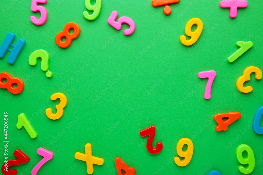 Fototapeta premium Many colorful numbers on green background with copy space.