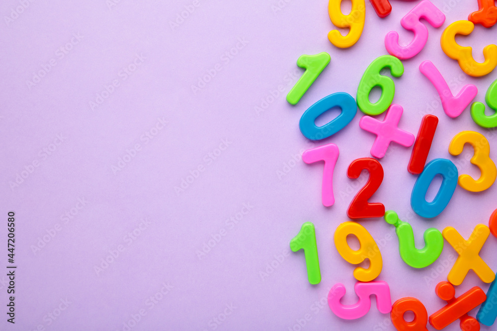 Magnetic multi-coloured figures on purple background with copy space. Back to school. Magnetic multi-coloured figures on purple background with copy space. Back to school.