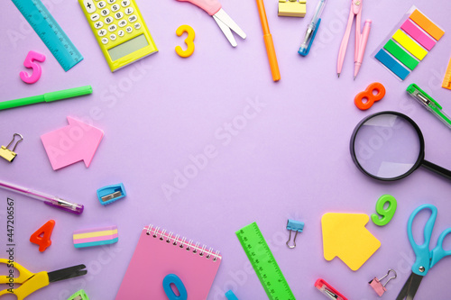 School supplies on purple background. Back to school concept.