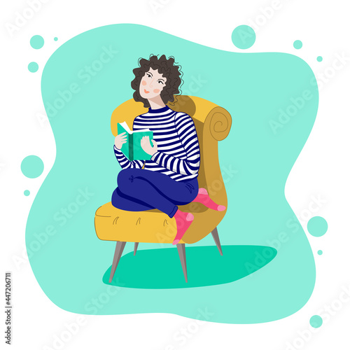 A girl in a chair reading a book