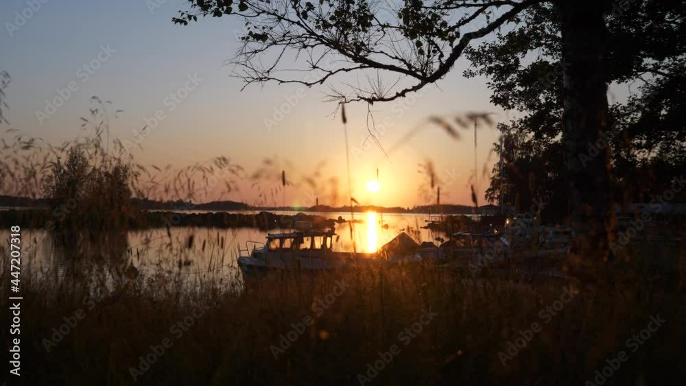 Beautiful Nordic sunset with boats docked at small lake pier, truck left Beautiful Nordic sunset with boats docked at small lake pier, truck left