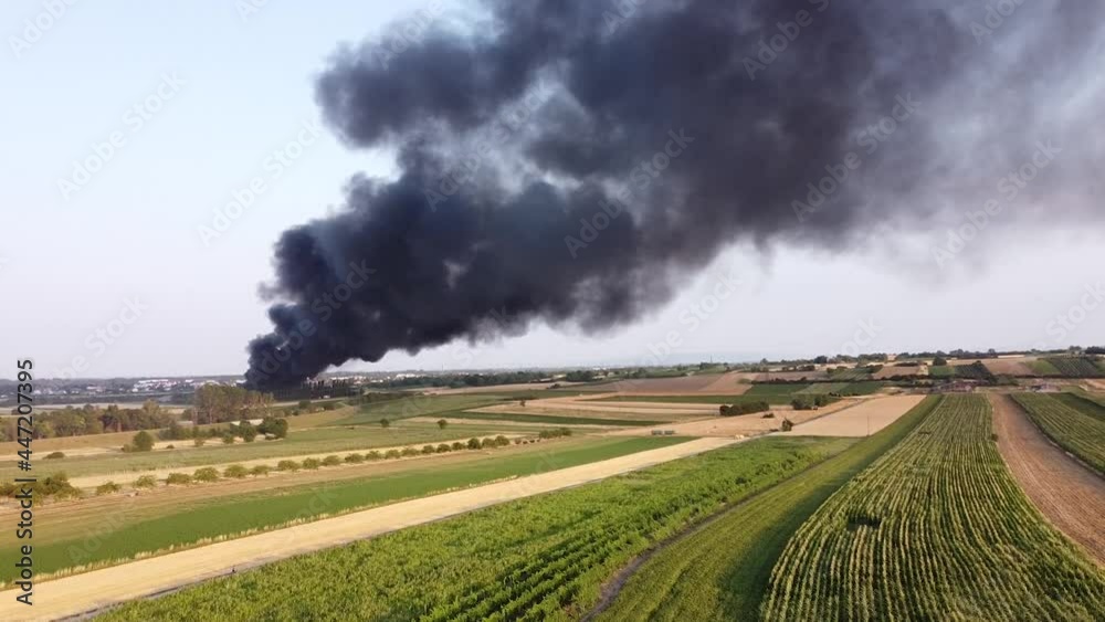 Large black smoke cloud from a fire - drones flying near a dark fog Large black smoke cloud from a fire - drones flying near a dark fog