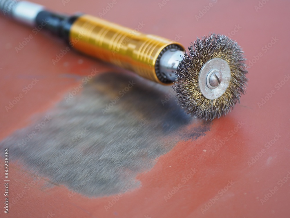 Rotary wire wheel brush. Cleaning of metal surfaces from rust and