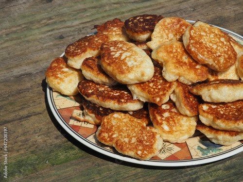 Plate with pancakes. Stack of golden pancakes. Home cooked food photo