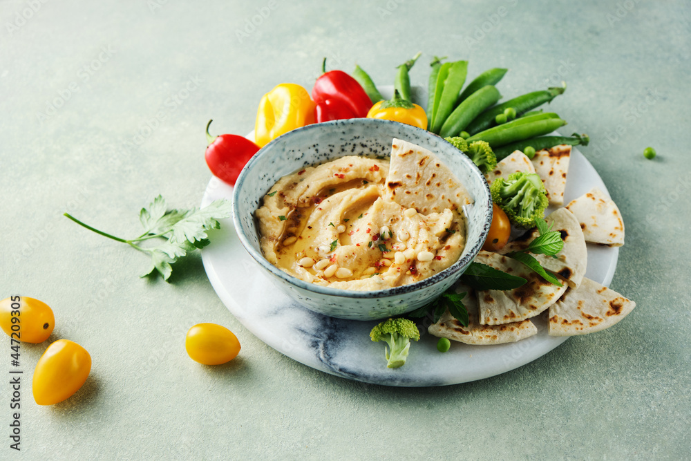 Classic hummus, slices of pita bread and rainbow vegetables. Classic hummus, slices of pita bread and rainbow vegetables.