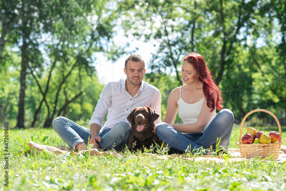 Couple with a dog in the park Couple with a dog in the park