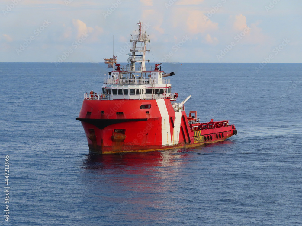 Supply boat transfer the cargo for supporting oil and gas industry and moving cargo from the boat to the platform. Boat is waiting transfer cargo and crews to platform. Supply boat transfer the cargo for supporting oil and gas industry and moving cargo from the boat to the platform. Boat is waiting transfer cargo and crews to platform.