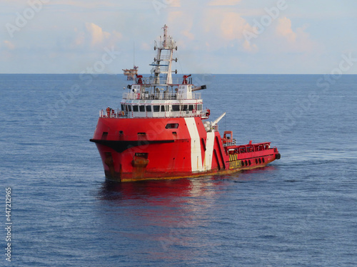 Supply boat transfer the cargo for supporting  oil and gas industry and moving cargo from the boat to the platform. Boat is waiting transfer cargo and crews to platform.