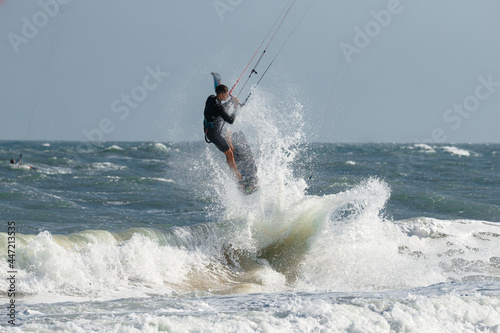 Kite surfer jumps with kiteboard in transition © Oleg