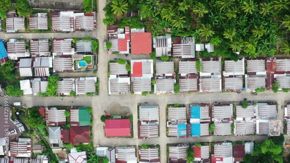 Settlement Roofscape Surrounded By Palm Woods At Saint Bernard Village, Southern Leyte, Philippines. - Aerial Ascending Shot Settlement Roofscape Surrounded By Palm Woods At Saint Bernard Village, Southern Leyte, Philippines. - Aerial Ascending Shot