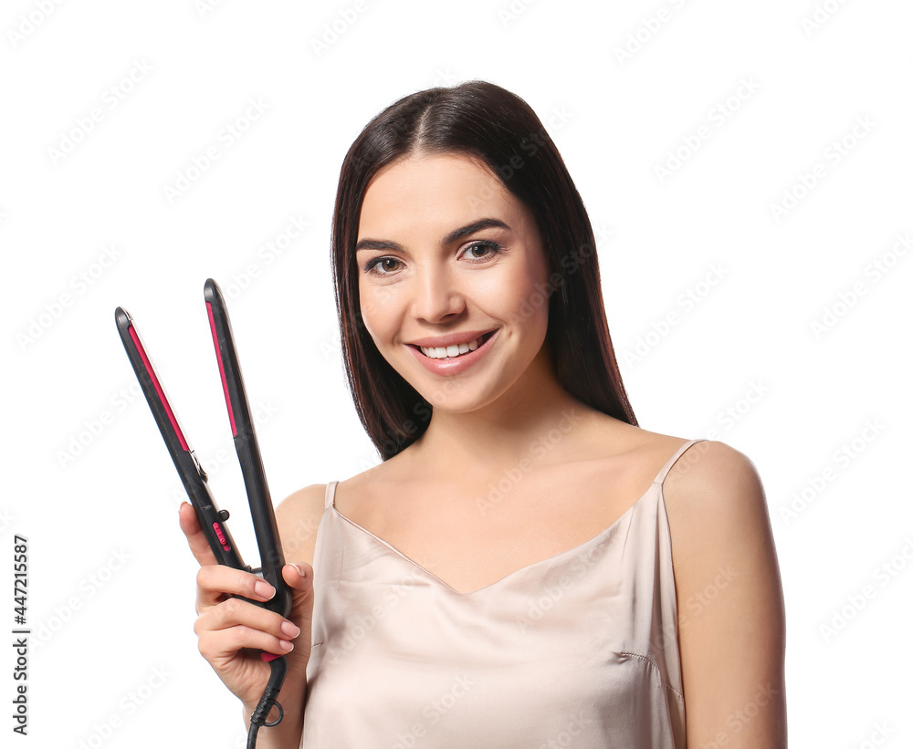Beautiful young woman with flattening iron on white background Beautiful young woman with flattening iron on white background