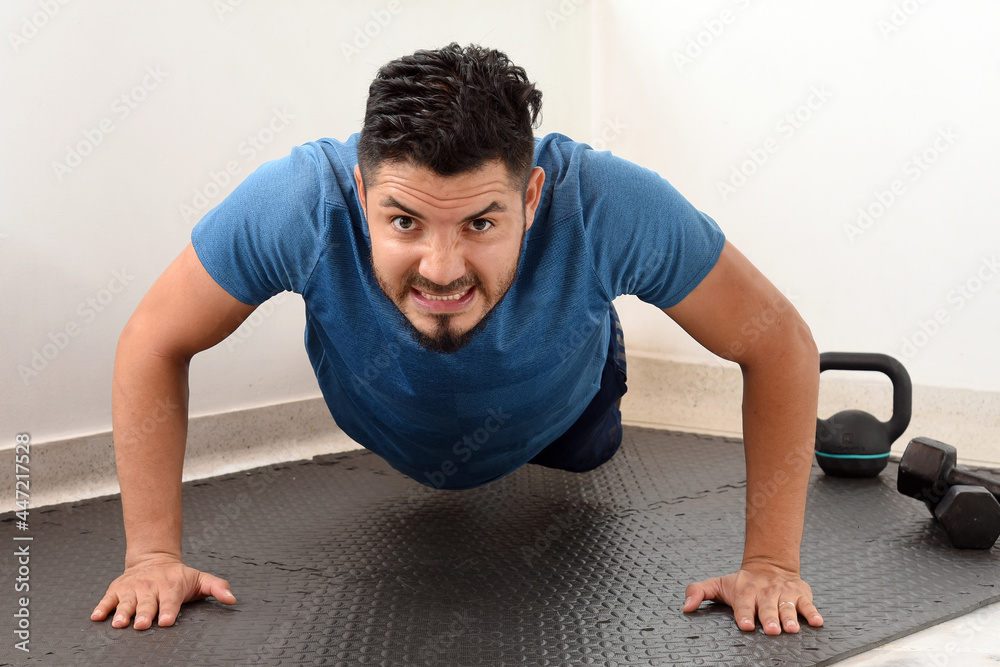 Caucasian athlete man doing push-ups. fitness at home young handsome man in sportswear doing push-ups. doing pectoral exercises Caucasian athlete man doing push-ups. fitness at home young handsome man in sportswear doing push-ups. doing pectoral exercises