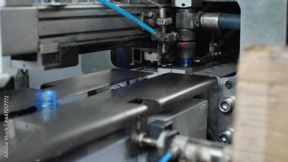 Close-up of plastic bottles coming out of the bottle blowing machine. Plant for the production of drinking and mineral water