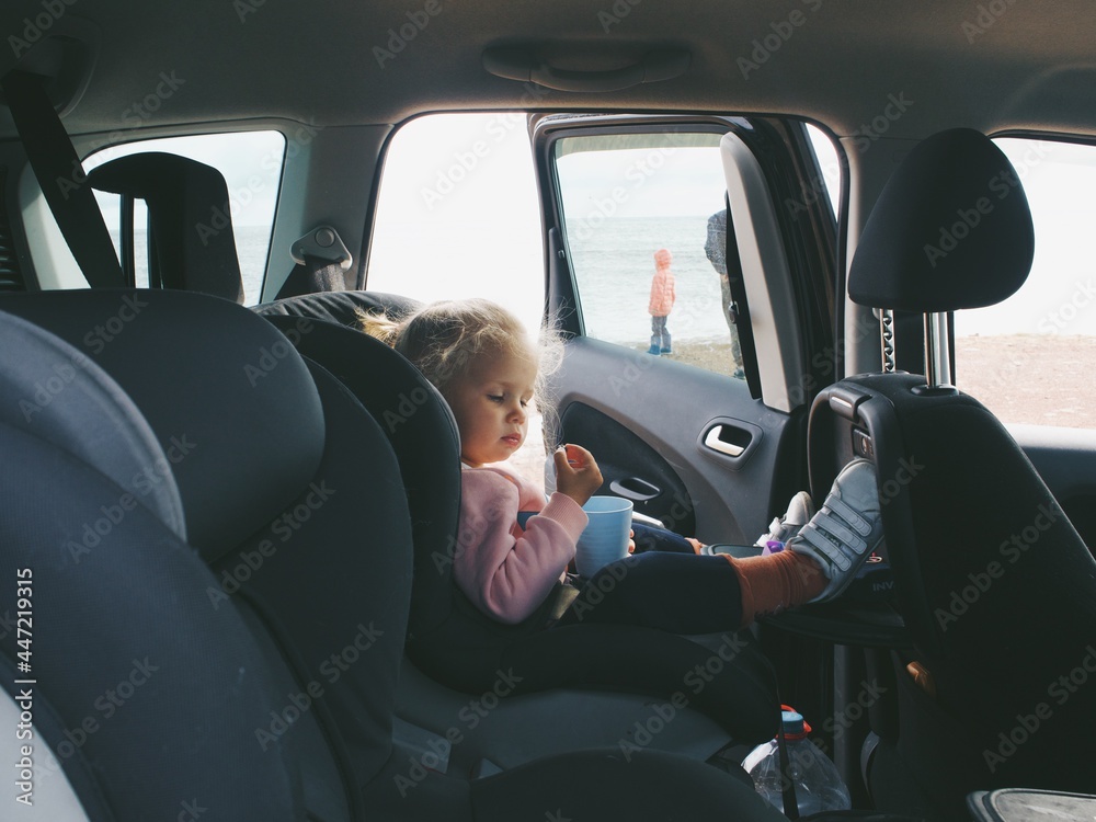 child in a car seat in a car, travel