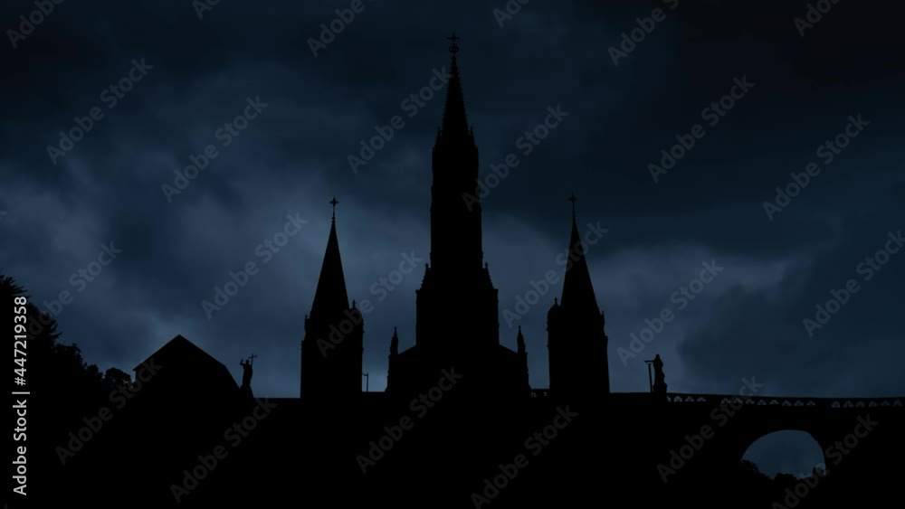 Lightning and Thunderstorm flash over Dark Silhouette of Cathedral In Lourdes, France Lightning and Thunderstorm flash over Dark Silhouette of Cathedral In Lourdes, France