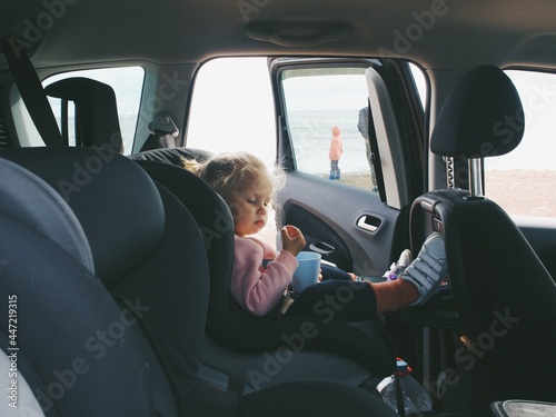child in a car seat in a car, travel © Maria Davy