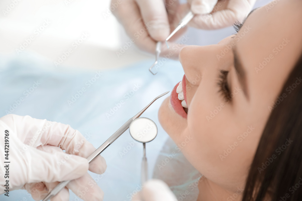 Young woman visiting dentist in clinic, closeup Young woman visiting dentist in clinic, closeup
