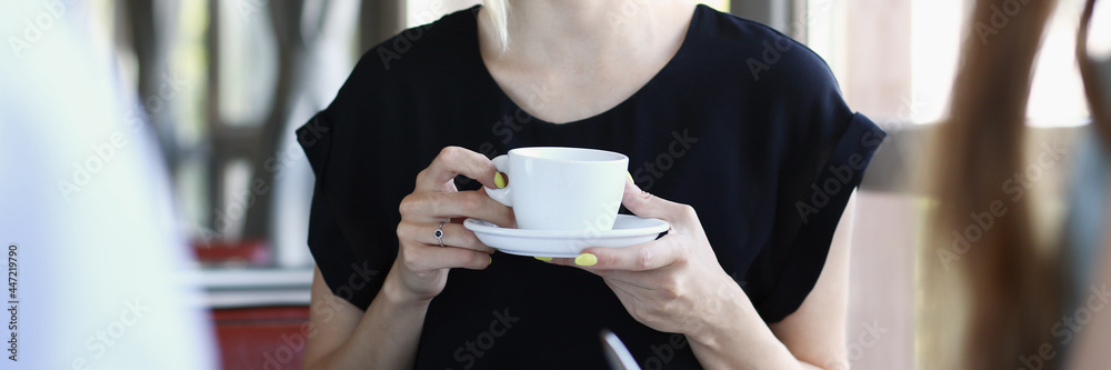 Woman blonde talking to friends in a cafe for a cup of coffee Woman blonde talking to friends in a cafe for a cup of coffee
