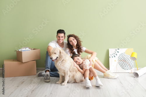 Happy family with dog and b...