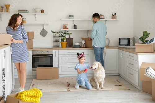 Happy family with dog and b...