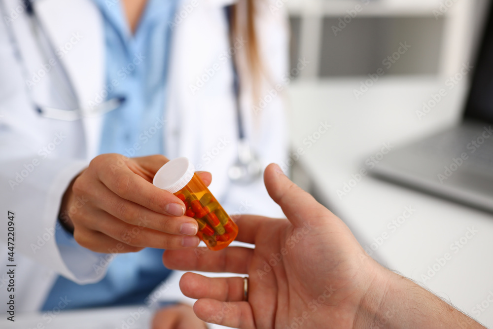 Female medicine doctor write prescription at worktable while Female medicine doctor write prescription at worktable while