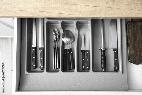 Drawer with set of knives in kitchen