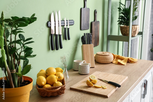 Set of knives and lemons on counter in kitchen photo