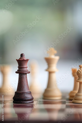 wooden chess pieces on board game.