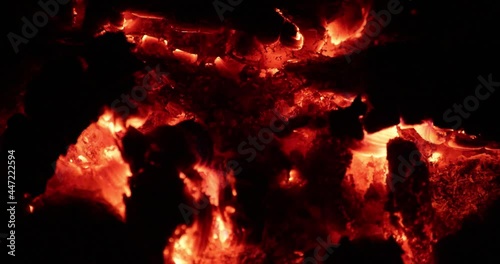 Slow motion close-up view of burning embers from a campfire.