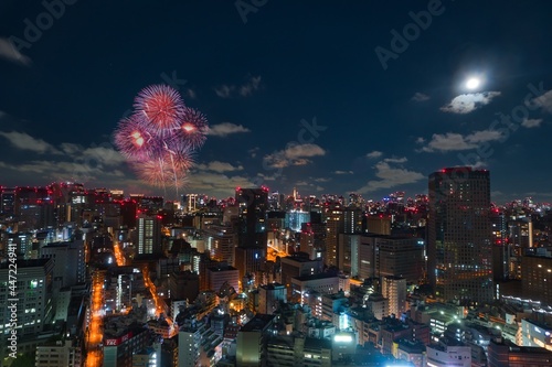 Photography Night city view of the central urban area of Tokyo with fireworks and moon in th