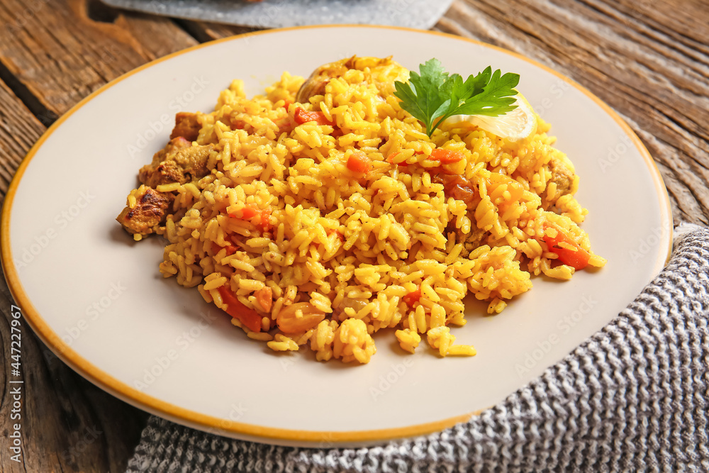 Plate with tasty pilaf on wooden background, closeup Plate with tasty pilaf on wooden background, closeup