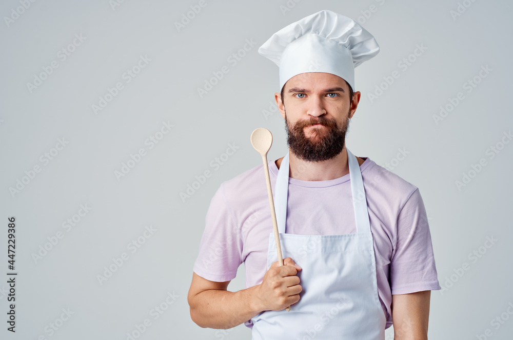 emotional bearded chef with a cap on his head holds a spoon in his hands restaurant Professional emotional bearded chef with a cap on his head holds a spoon in his hands restaurant Professional