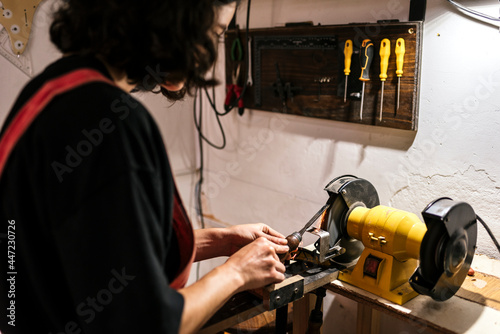 Unrecognized luthier woman in traditional workshop