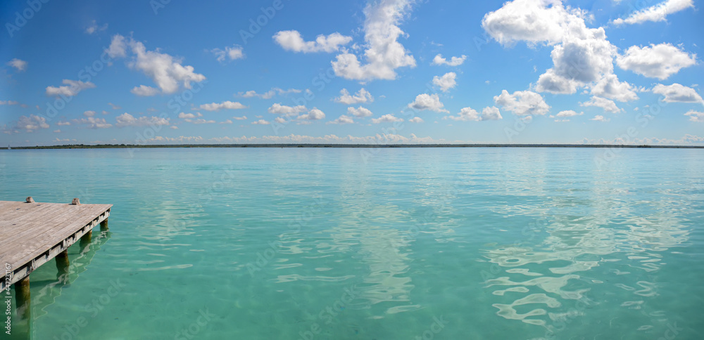 Panoramic view of Bacalar lagoon in Mexico. Shore lake with turquoise transparent water with copy space. tropical summer travel destination. Exotic and Caribbean vacation.