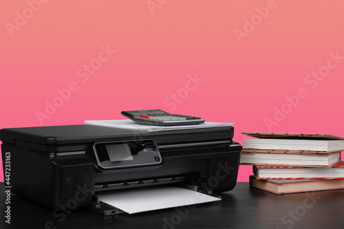 Compact home laser printer against pink background