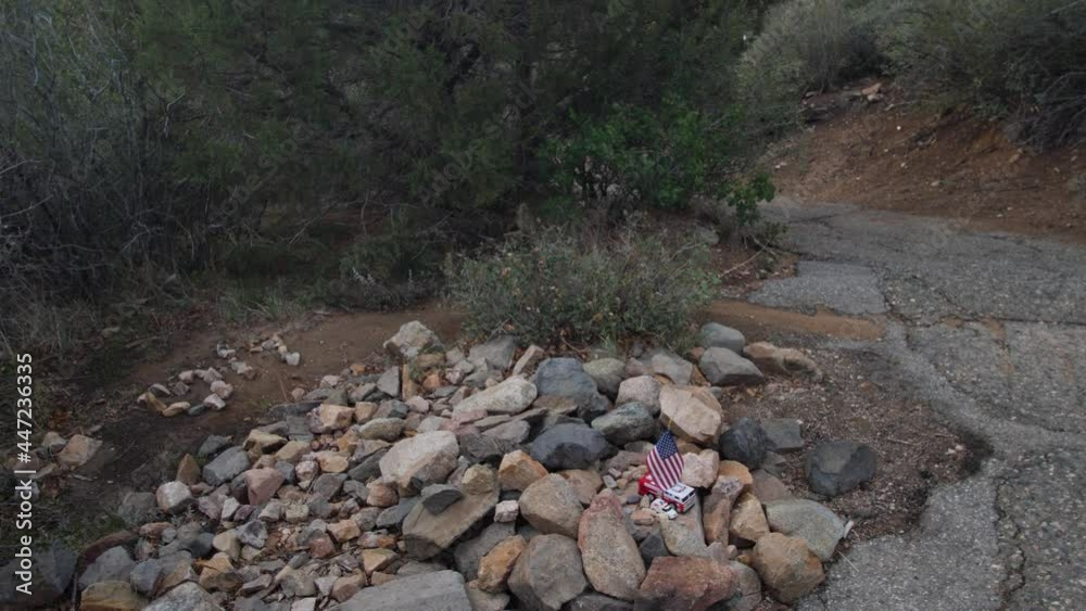 Left pan over a mountain trail memorial for firefighters. Left pan over a mountain trail memorial for firefighters.