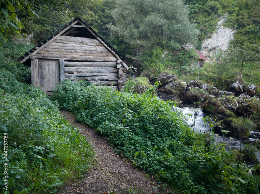 Small traditional wooden water mill by the wild river Krupa with big rocks and cascades on popular tourist place Krupa na Vrbasu near Banja luka, Bosnia and Herzegovina. Small traditional wooden water mill by the wild river Krupa with big rocks and cascades on popular tourist place Krupa na Vrbasu near Banja luka, Bosnia and Herzegovina.