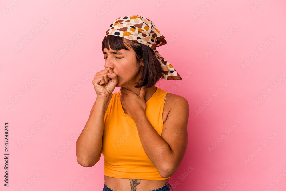 Young mixed race woman isolated on pink background suffers pain in throat due a virus or infection. Young mixed race woman isolated on pink background suffers pain in throat due a virus or infection.