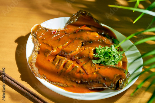 Spicy whole flounder fried with sweet and sour sauce. Chinese cuisine. photo