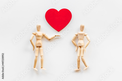 Man and woman connection. Couple of wooden mannequin figures with heart