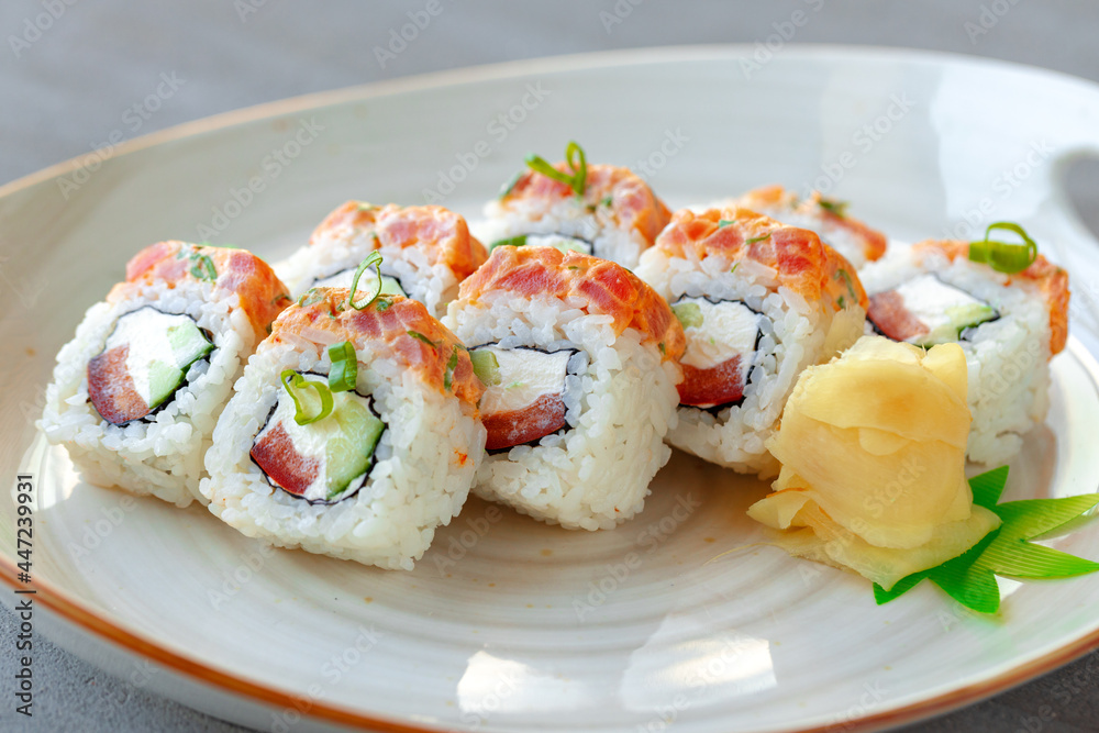 Japanese sushi roll with salmon on plate Japanese sushi roll with salmon on plate