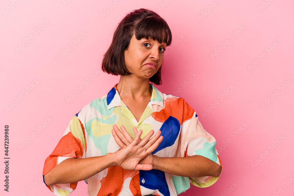 Young mixed race woman isolated on pink background doing a denial gesture Young mixed race woman isolated on pink background doing a denial gesture