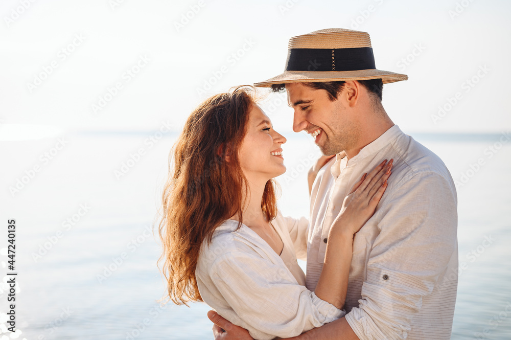 Side view smiling young couple two family man woman wear casual clothes girlfriend hugging boyfriend rest date at sunrise over sea sand beach ocean outdoor exotic seaside in summer day sunset evening.