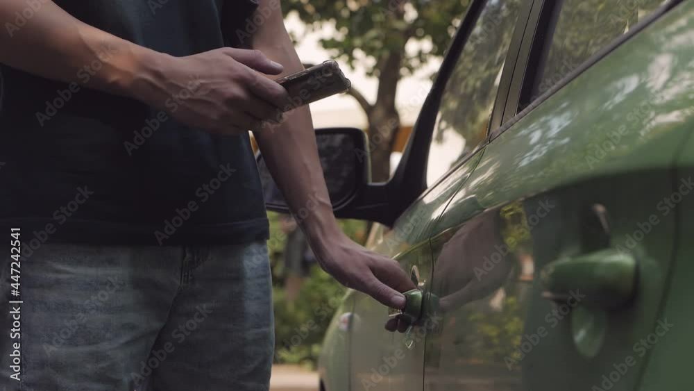 Man unlocks car door with phone app. Car sharing, transport. Man unlocks car door with phone app. Car sharing, transport.