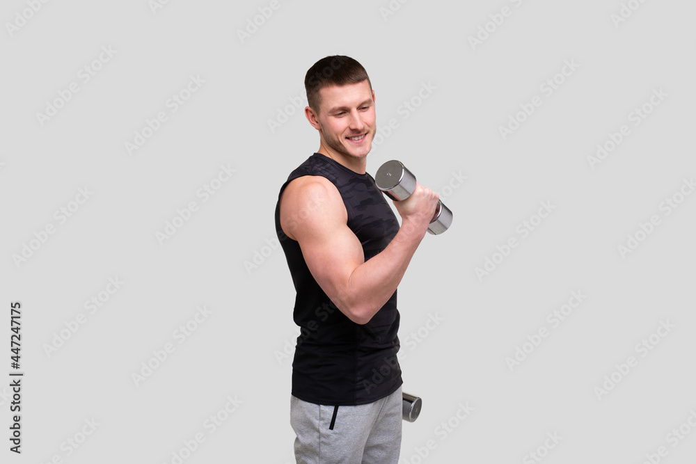 Man Pumping Biceps with Dumbbell. Sprotsman Doing Traning on Biceps Muscles. Gym, Lifting Sport Concept. Man Pumping Biceps with Dumbbell. Sprotsman Doing Traning on Biceps Muscles. Gym, Lifting Sport Concept.