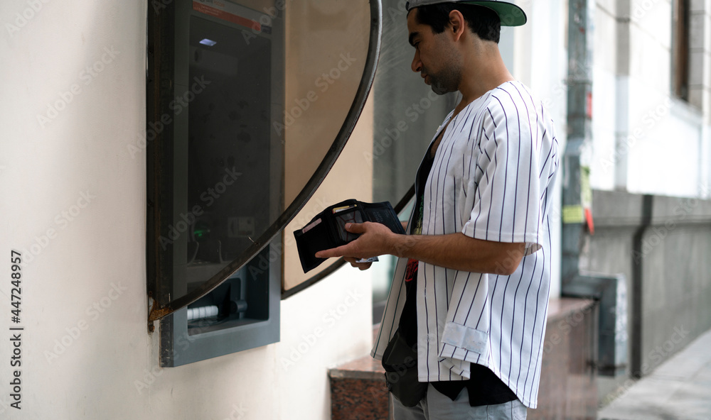close up person using ATM to take some cash money from bank card close up person using ATM to take some cash money from bank card