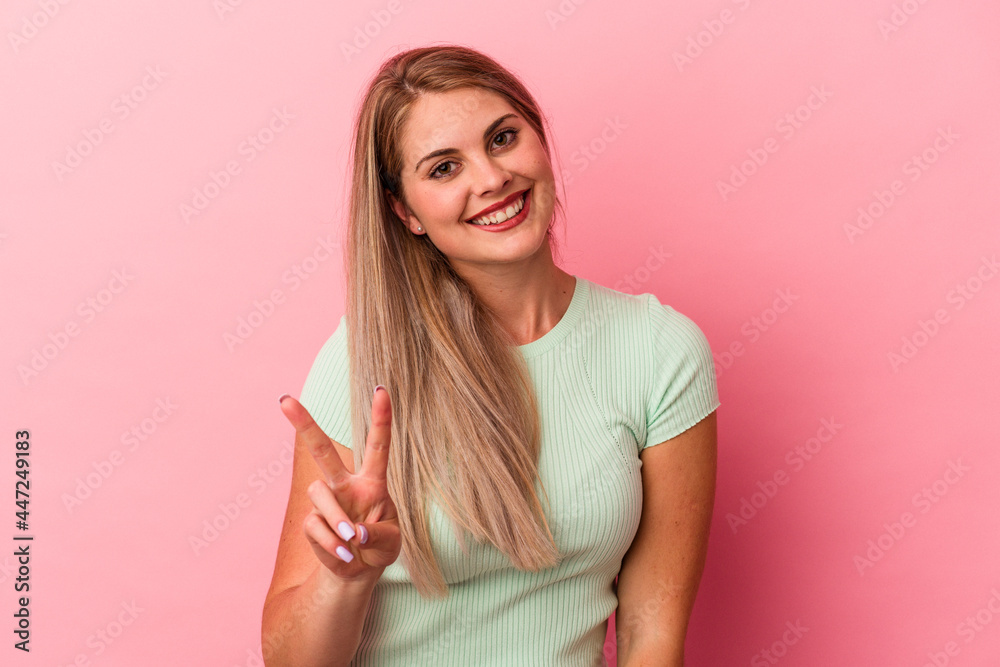 Young russian woman isolated on pink background showing number two with fingers. Young russian woman isolated on pink background showing number two with fingers.
